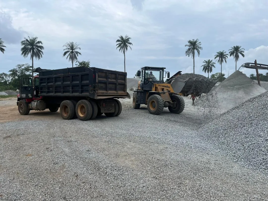 Wheel loader filling a tipper truck with granite aggregate at Okeigbo Quarry
