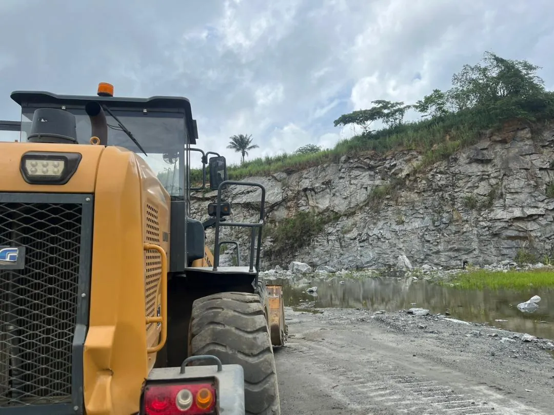 Wheel loader working beside the granite rock face at Owena Quarry