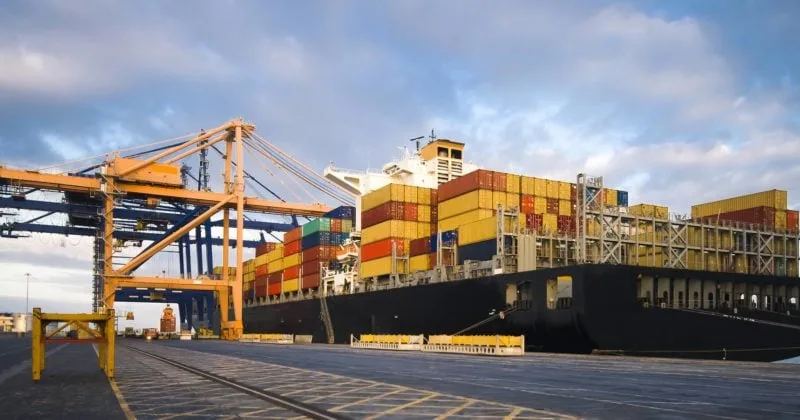 Container ship and port cranes loading cargo for international trade